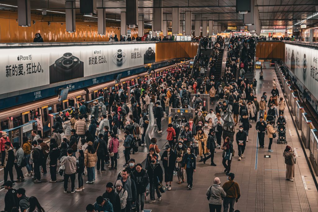 outdoor-image-02 Overhead view of a bustling crowd at a metro station platform in Taipei, Taiwan.